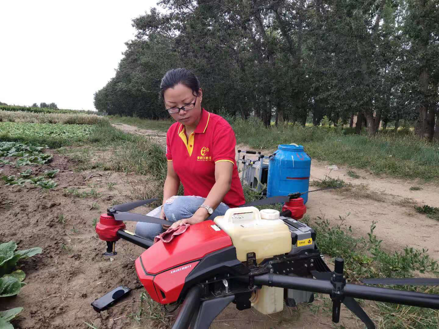 sheng guangning and her crop spraying drone