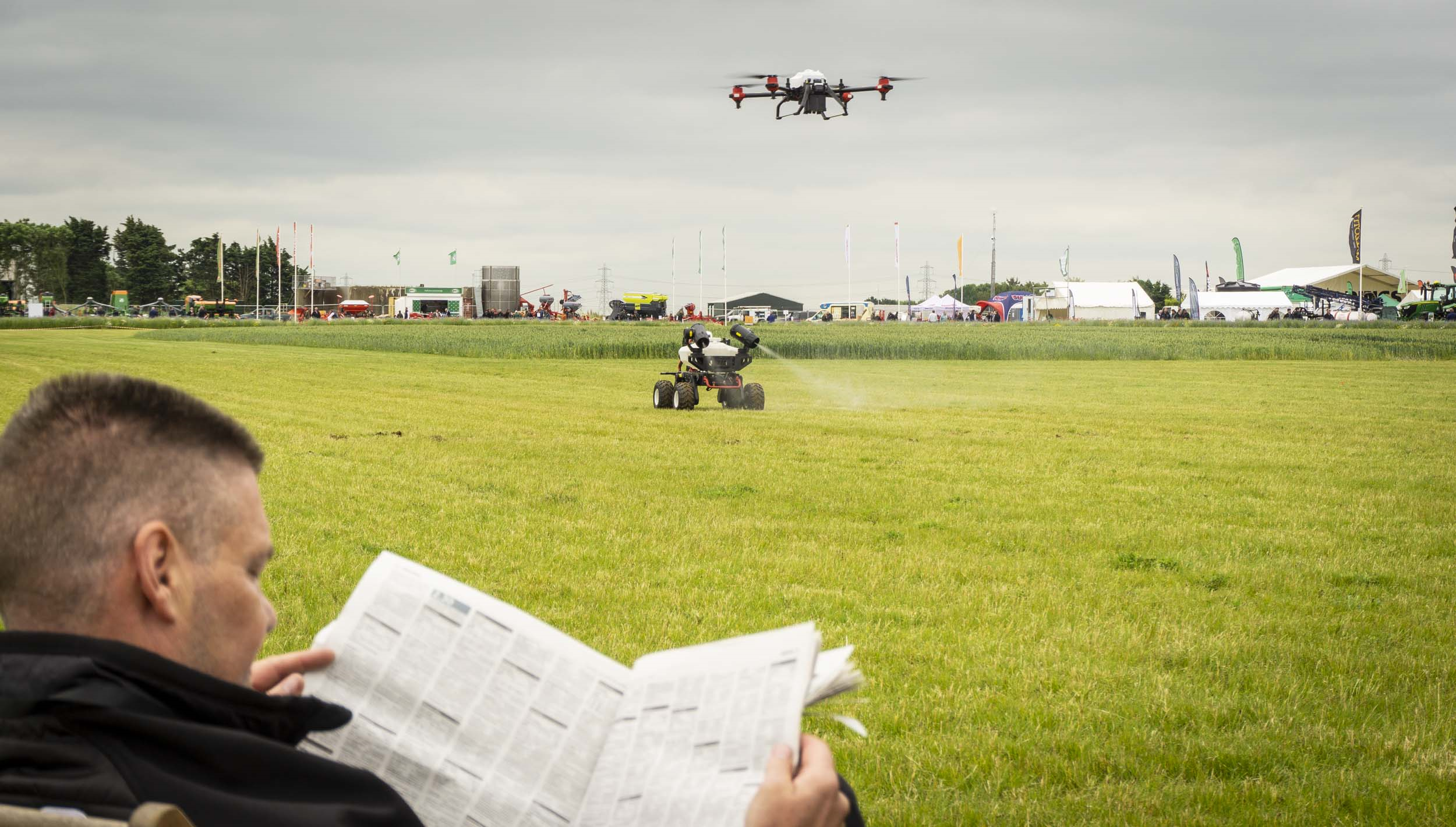 farmer enjoys reading while the robot do the job autonomously 