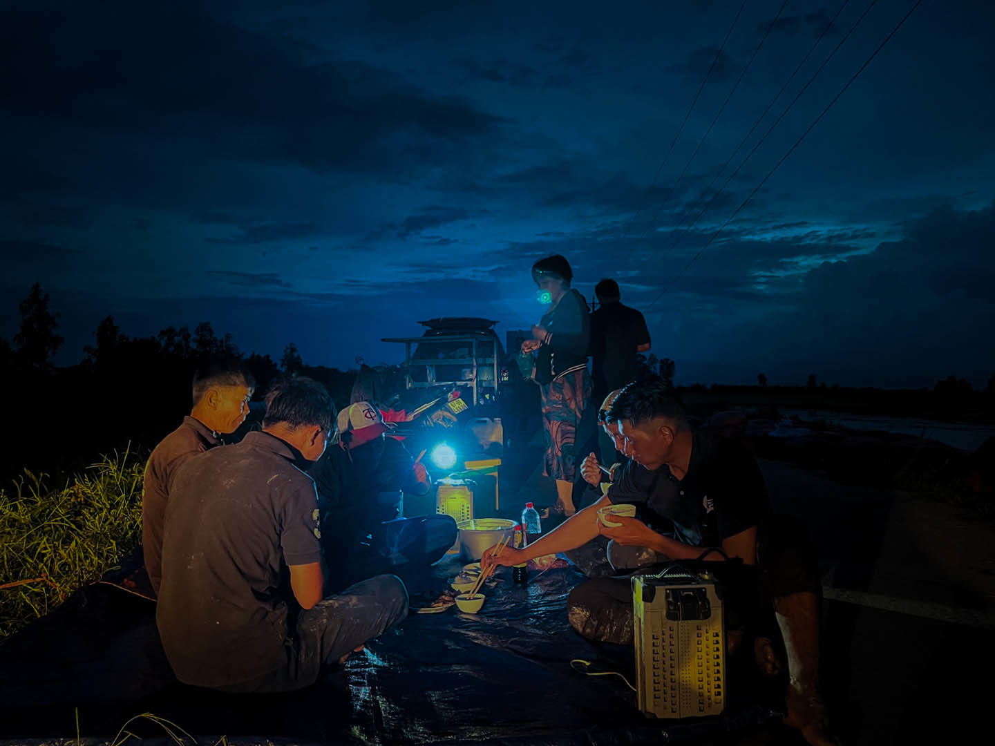 the pilot team was having the dinner by the field after a long day of work